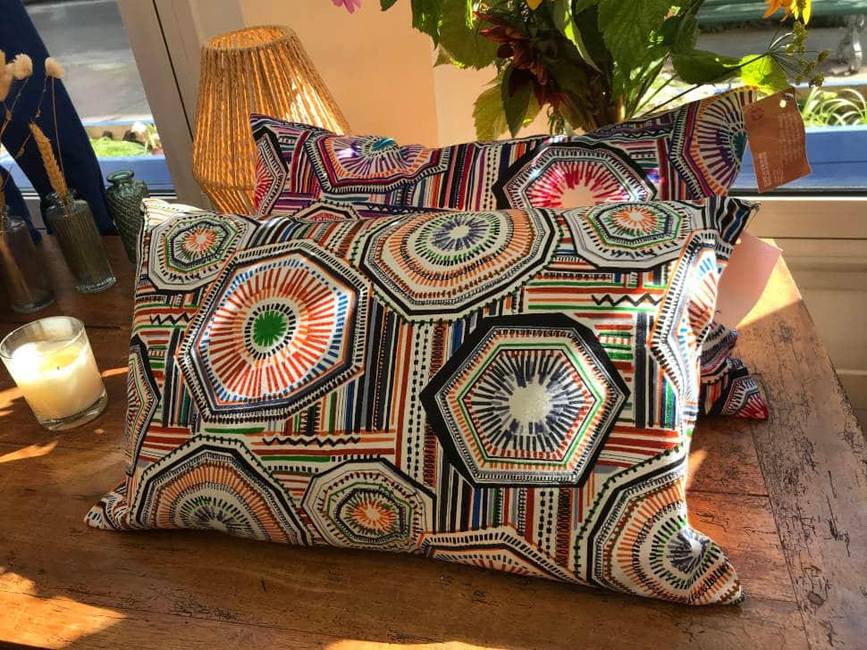 Des coussins sur un meuble issus du travail d'upcycling de l'Armée du Salut Des coussins sur un meuble issus du travail d'upcycling de l'Armée du Salut